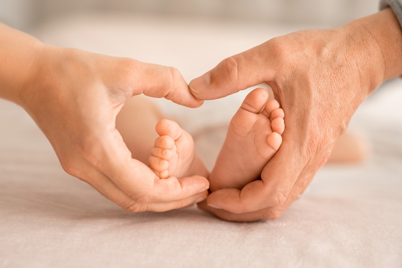 little-baby-feet-in-mother-and-father